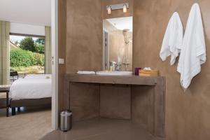 a bathroom with a sink and a mirror and a bed at Hôtel 96 in Marseille