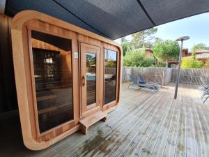 a house with a large glass door on a deck at Domaine du Ferret Restaurant & Spa in Cap-Ferret
