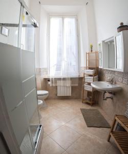 a bathroom with a shower and a toilet and a sink at La Magnolia in Livorno +35 photos