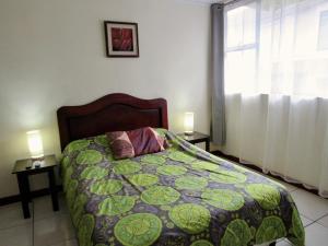 Postel nebo postele na pokoji v ubytování Hotel La Guaria Inn & Suites