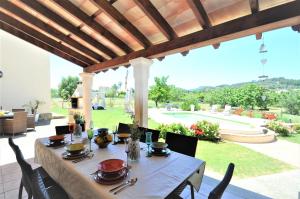 a table with plates and utensils on a patio at C277 Son Rubi by Mallorca Villa Selection in Selva
