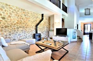 a living room with a couch and a tv at C277 Son Rubi by Mallorca Villa Selection in Selva