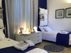Postel nebo postele na pokoji v ubytování Il Piccolo Rooms