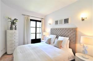 a white bedroom with a large bed and a window at C277 Son Rubi by Mallorca Villa Selection in Selva +48 photos