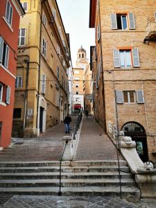 a group of stairs in an alley between buildings at La Sibilla in Macerata