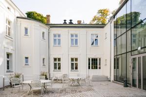 an empty courtyard in a building with tables and chairs at Kasztanowy Pałac in Swadzim