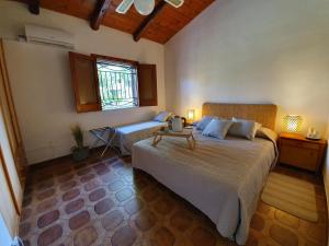 a bedroom with two beds and a window at Villa Plemmyria in Syracuse