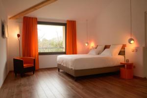 a bedroom with a bed and a window and a chair at Hôtel 96 in Marseille