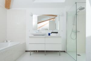 a white bathroom with a sink and a shower at Hôtel 96 in Marseille