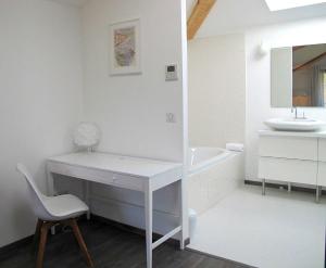a white bathroom with a desk and a sink at Hôtel 96 in Marseille