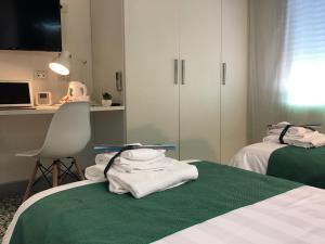 Postel nebo postele na pokoji v ubytování Il Piccolo Rooms