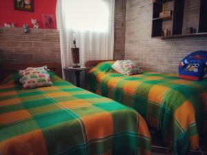 Postel nebo postele na pokoji v ubytování El Pedregal Sopó