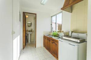 a kitchen with a sink and a counter top at SoulSurfcamp Portugal in Peniche +54 photos