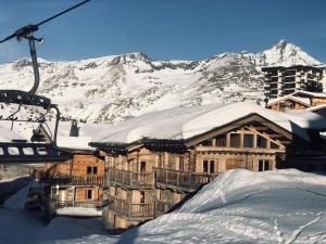a ski lodge in the snow with a ski lift at Chalet Le Cordava in Tignes