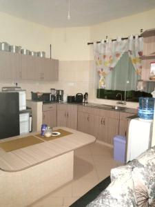 a kitchen with a table and a counter top at BLUE NILE 9 - SUNSET HOLIDAY APARTMENTS, SHANZU - Mombasa in Mombasa +13 photos