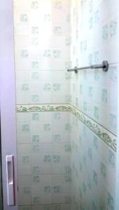 a bathroom with a shower with blue and white tiles at BLUE NILE 9 - SUNSET HOLIDAY APARTMENTS, SHANZU - Mombasa in Mombasa