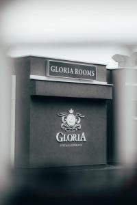 a sign for a store with a clola rooms at Gloria Rooms in Požega