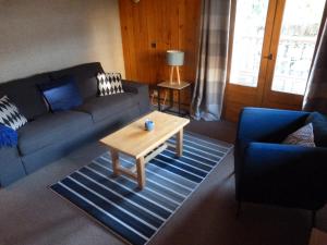a living room with a couch and a coffee table at Chalet Le Cordava in Tignes