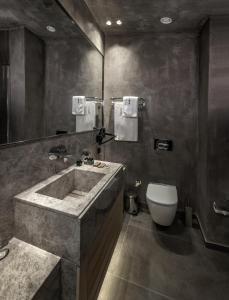 a bathroom with a large sink and a toilet at Hotel Bosfora Plus in Istanbul