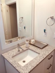 a bathroom with a sink and a mirror at Your home away from home in Kelowna