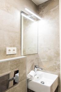 y baño con lavabo y espejo. en Tourist House Odonell, en Sevilla
