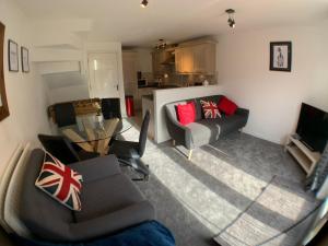 a living room with a couch and a table at Harpers brook house, Netflix TVs and fast WIFI in Corby