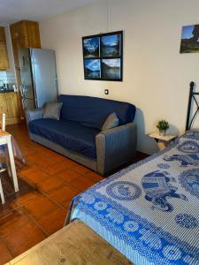 a living room with two beds and a couch at Apto en Mesa del Mar in Puerto de la Madera