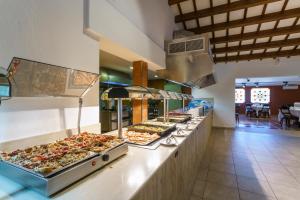 a buffet line with many different types of pizzas at Minura Cala Galdana & Apartamentos d'Aljandar in Cala Galdana