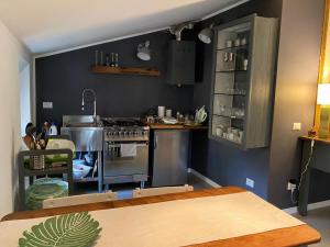 a kitchen with a stove and a table in it at Sweet Dream Loft in Verona