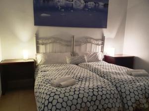 a bedroom with a bed with two pillows on it at Apartamentos Turísticos La Encarnación in Seville