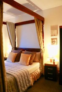 a bedroom with a bed with a canopy at The Liverpool Pod Travel Hostel in Liverpool