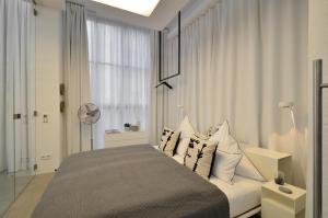 a bedroom with a bed with pillows and a window at Luxury Omaruru-Design-Apartment Deluxe in Munich