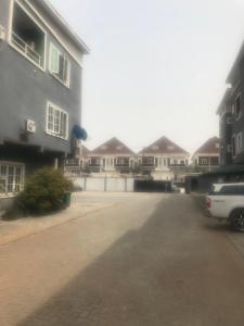 a car parked in a parking lot next to some houses at Studio One Bed Apartment - Off Chevron Drive in Lekki
