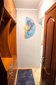 a hallway with a door and a clock on the wall at Apartments in the park area of the Dnipro in Dnipro