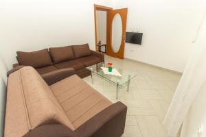 a living room with a couch and a table at Apartments Petković in Petrovac na Moru