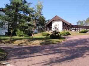 a house with a driveway in front of it at Hotel Astra in Tuchlovice