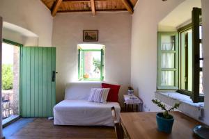 a bedroom with a bed and a green door at Axion Studios in Aroniadika