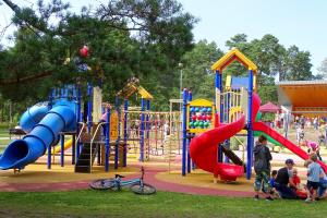 a group of children playing in a playground at Ventspils Seaside Lux Apartments in Ventspils