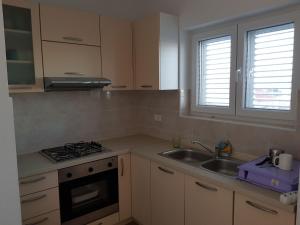 a kitchen with a sink and a stove at Contemporary Apartment in Neviđane near Sea in Neviđane