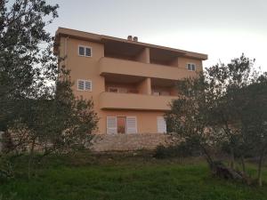 a large building in the middle of a field at Contemporary Apartment in Neviđane near Sea in Neviđane
