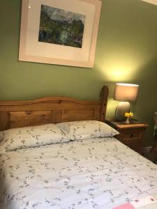 1 dormitorio con 1 cama y una foto en la pared en 28 Hillside, en Lochinver