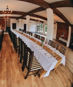 a long dining room with a long table with chairs at Port Jabłonka in Jabłonka