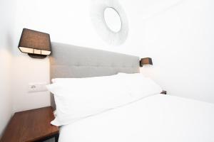 Benigno Premium Center客房内的一张或多张床位