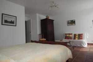 a bedroom with a bed and a table and a chair at Les Vallées du Guyoult in Dol-de-Bretagne