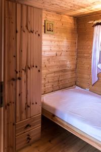 ヤロスワビエツにあるDomki letniskowe SILVERの木造キャビン内のベッド1台が備わるベッドルーム1室を利用します。