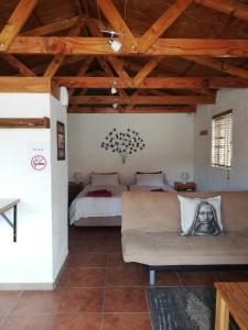 a bedroom with a bed and a couch in a room at Walvis Bay Backpackers & Self-catering in Walvis Bay