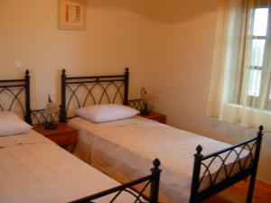 a bedroom with two beds and a window at Terra Lemnia A in Repanídhion