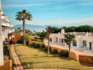 a view from the balcony of a house with palm trees at Beautiful New Apartment with Sea View in Castillo de Sabinillas