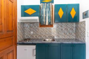 a kitchen with blue cabinets and a sink at Surfer Paradise in Naxos Chora +119 photos