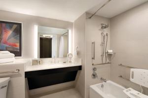 a bathroom with a sink, toilet and bathtub at Swissotel Chicago in Chicago